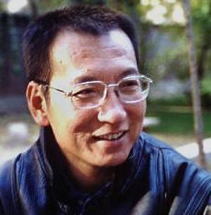 Liu Xiaobo wearing glasses and smiling outdoors.