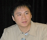 Wang Dan in a light shirt, looking to the right.