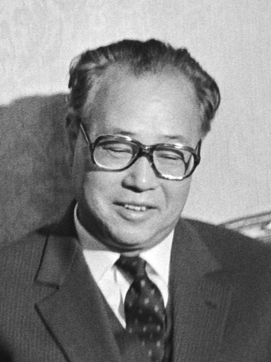 Black-and-white photograph of Zhao Ziyang in glasses and a suit.